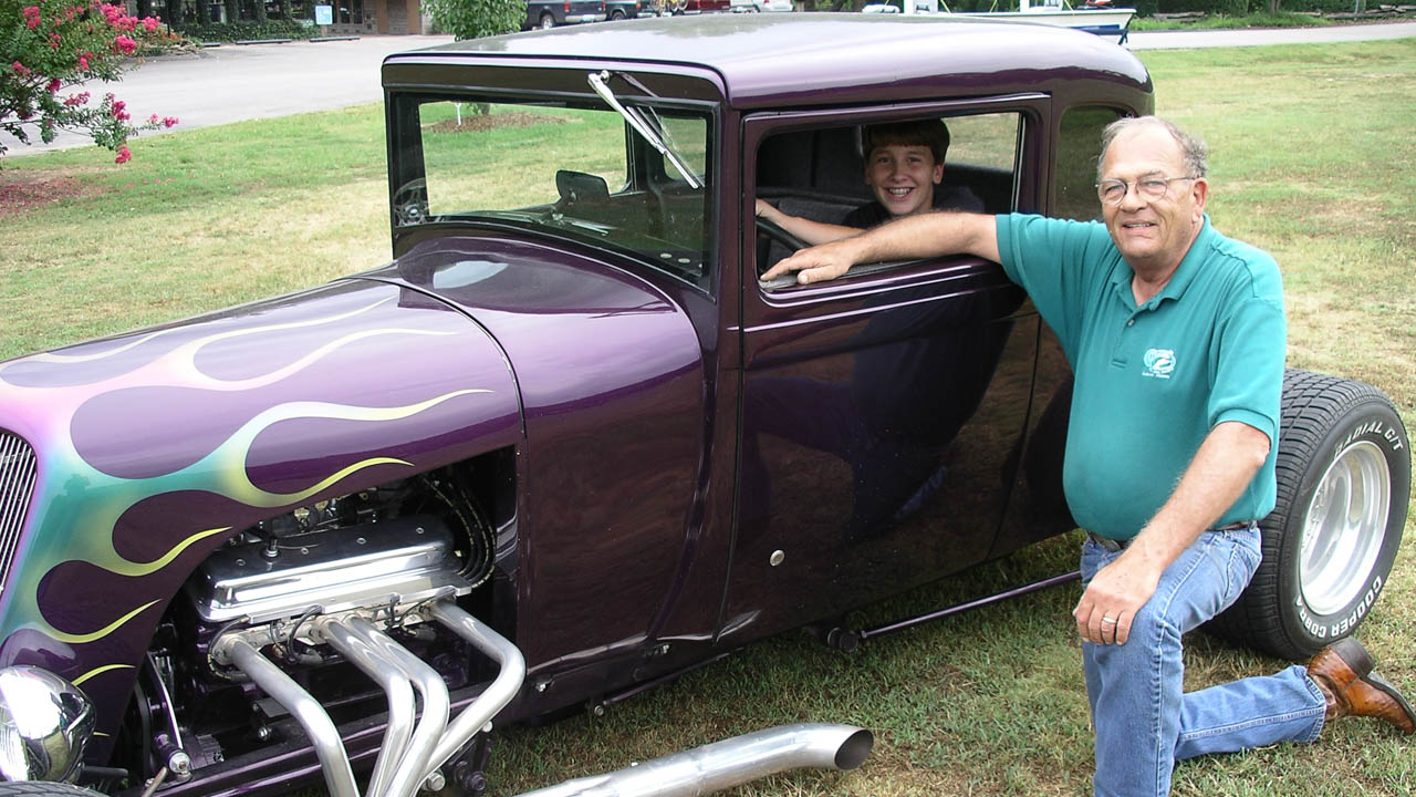 Jim Gaston and grandson Clint in the driver's seat with one of his antique cars