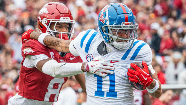 Ole Miss wide receiver Jordan Watkins pulls away from Razorbacks Jayden Johnson