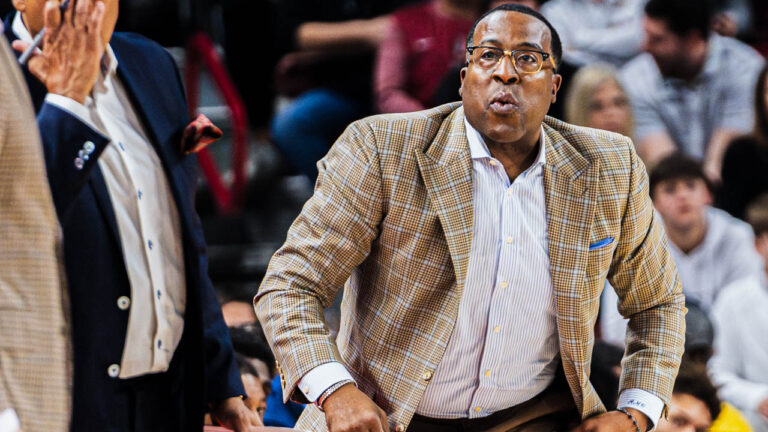 Razorbacks assistant Ronald "Chin" Coleman going down the sidelines in a game against Troy