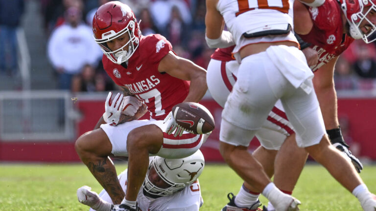 Razorbacks wide receiver CJ Brown fumbles after having the ball punched out by Texas defender.