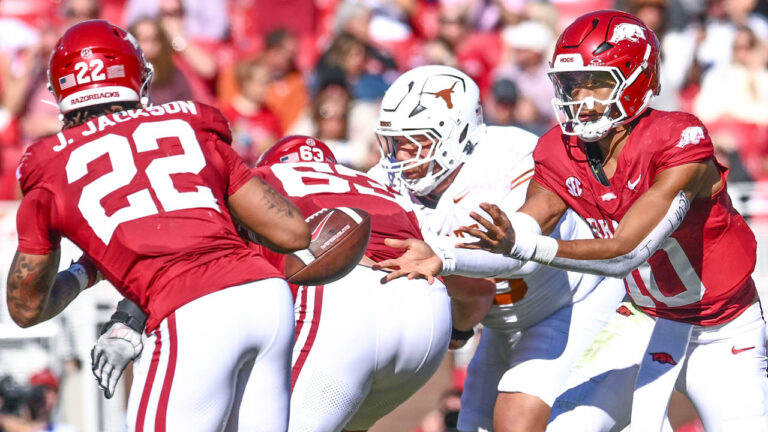 Razorbacks quarterback hands off to running back Ja'Quinden Jackson against Texas