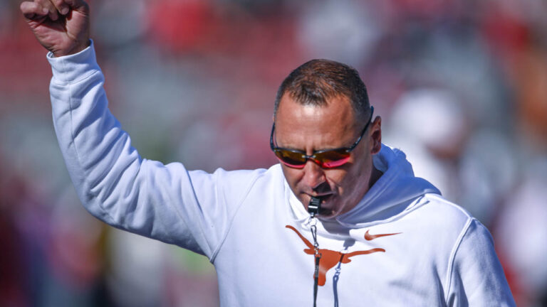 Longhorns coach Steve Sarkisian on the field before playing Arkansas