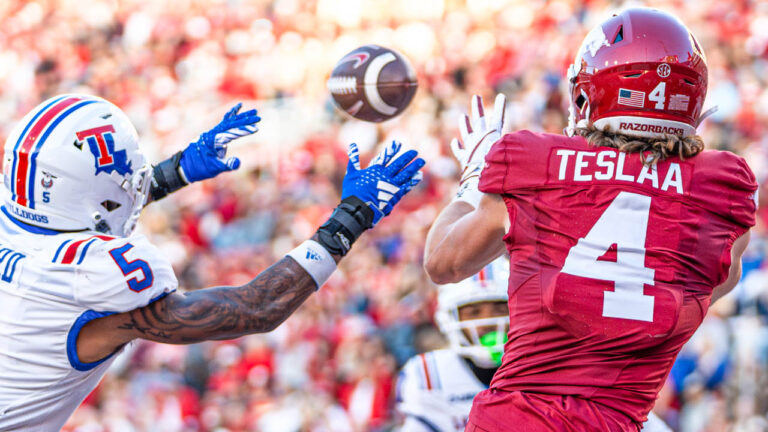 Razorbacks receiver Isaac TeSlaa reaches to catch a touchdown pass against Louisiana Tech