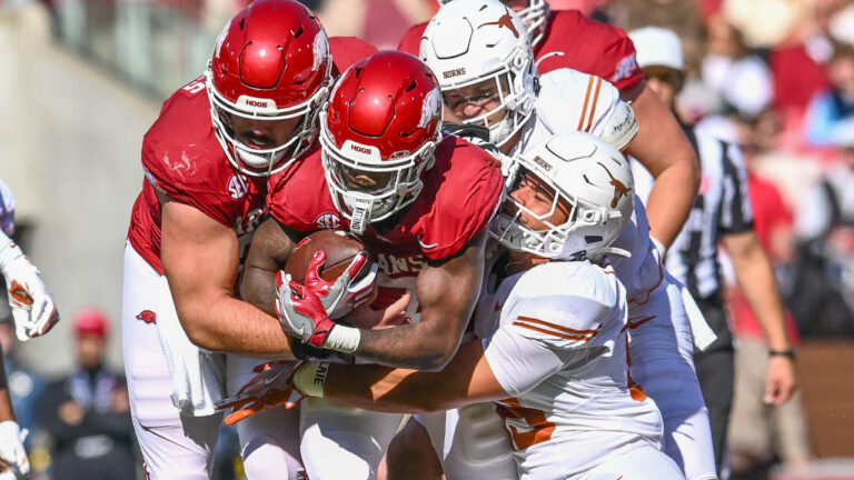 Razorbacks running back Rashod Dubinion is tackled by a Texas Longhorn