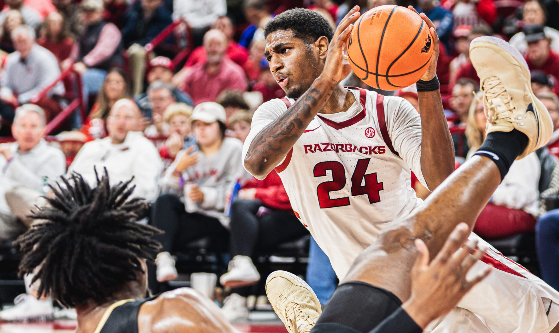 Razorbacks Billy Richmond goes up for a loose ball against Oakland