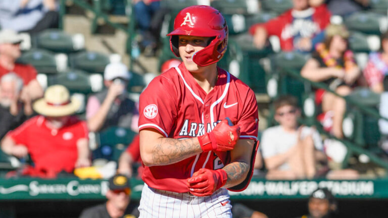Razorbacks designated hitter Kuhio Aloy gong to first base against Grambling