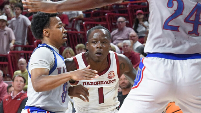 Razorbacks guard Johnell Davis drives inside against Kansas
