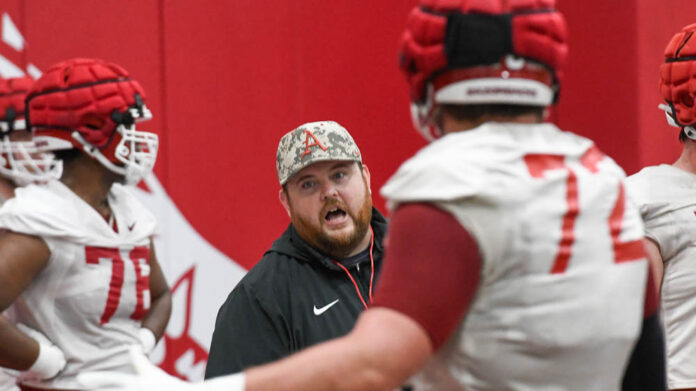Razorbacks offensive line coach Eric Mateos at a spring practice indoors