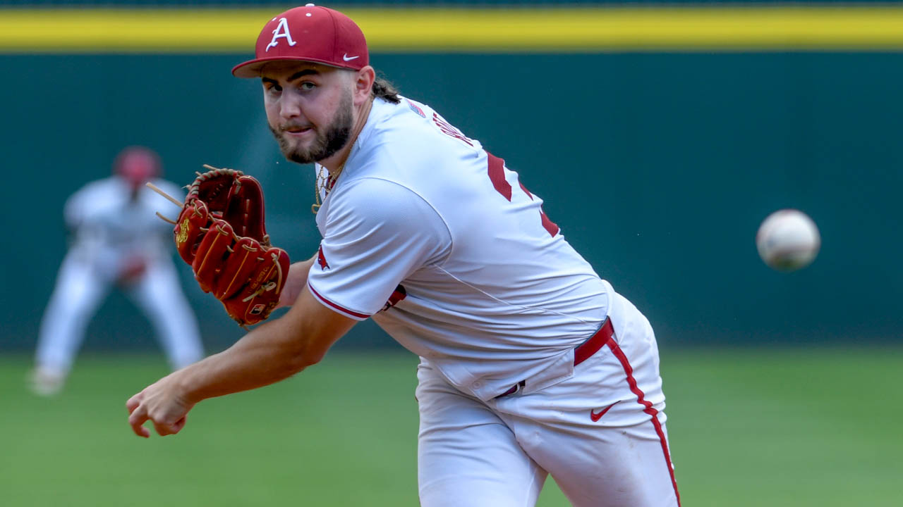 Razorbacks Zach Root throws to the plate against Tennessee