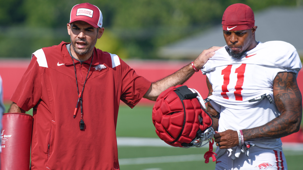 Arkansas Razorbacks wide receiver Monte Harrison (11) listens to coach Ronnie Fouch during preseason camp practices