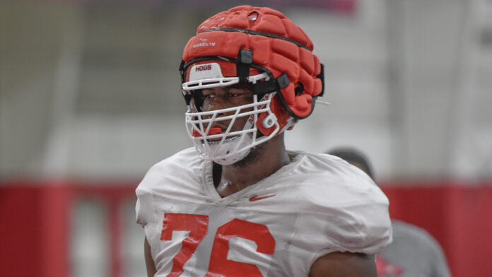 Arkansas Razorbacks offensive lineman E'Marion Harris at Thursday morning's media viewing section of practice