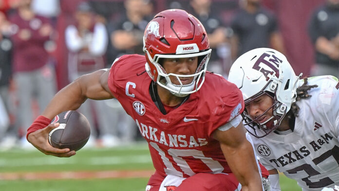 Arkansas Razorbacks quarterback Taylen Green is chased by Texas A&M Aggies linebacker Daymion Sanford