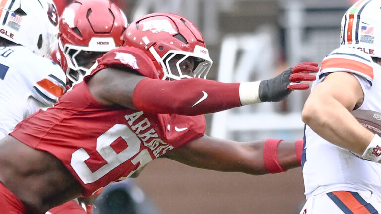 Arkansas Razorbacks defensive lineman Quincy Rhodes gets to Auburn Tigers quarterback Jackson Arnold