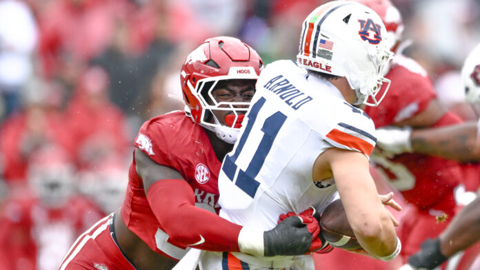 Arkansas Razorbacks defensive lineman Quincy Rhodes gets to Auburn Tigers quarterback Jackson Arnold