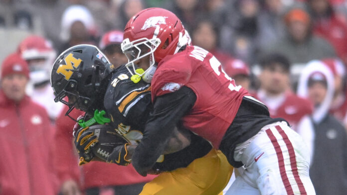 Arkansas Razorbacks defensive back Caleb Wooden brings down a Missouri Tigers receiver