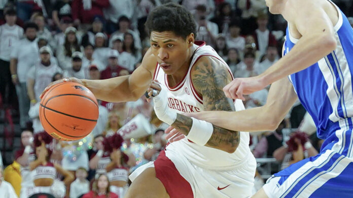 Arkansas Razorbacks guard Meleek Thomas drives against the Kentucky Wildcats