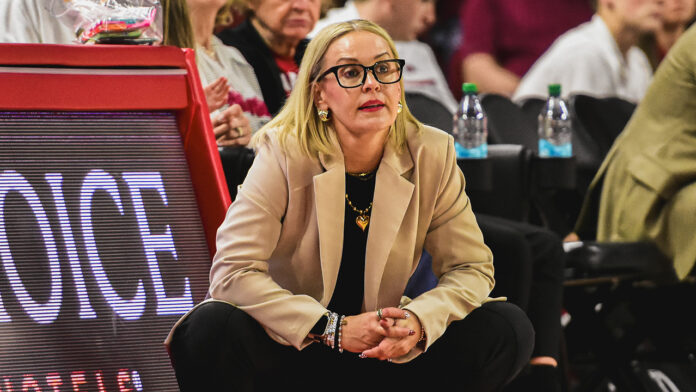 Arkansas Razorbacks coach Kelsi Musick on the sidelines against the Arkansas State Red Wolves