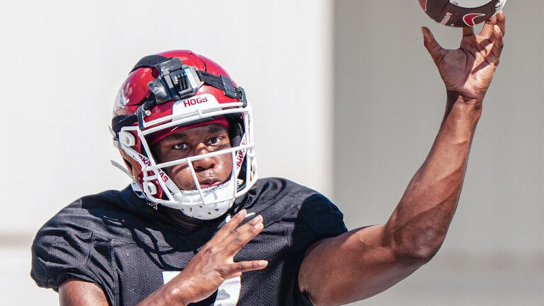 Arkansas Razorback quarterback KJ Jackson delivers a throw in a fall practice in Fayetteville, Ark.
