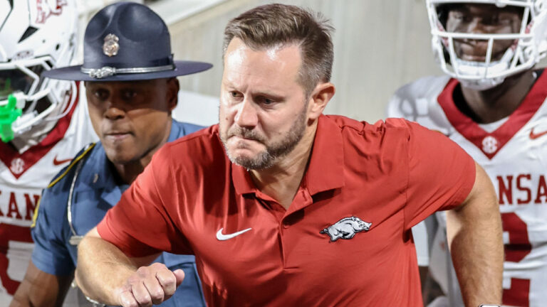 Arkansas Razorbacks coach Kyle Sutherland comes on the field against the Utah Utes