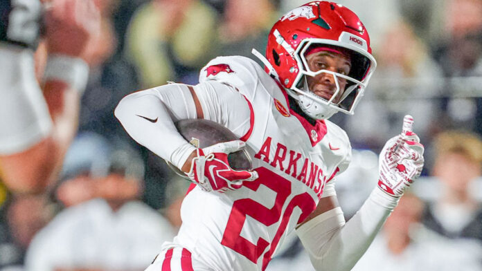 Arkansas Razorbacks defensive back Joker Johnson returns an interception for a score in a game against the Vanderbilt Commodores